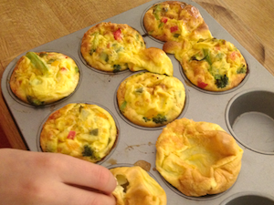 Tamara sampling one of the egg-only muffins right out the oven